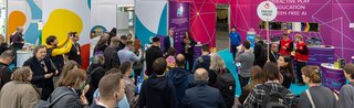 People at the entrance with ticket scanners in NCC Ost at Spielwarenmesse Nuremberg.